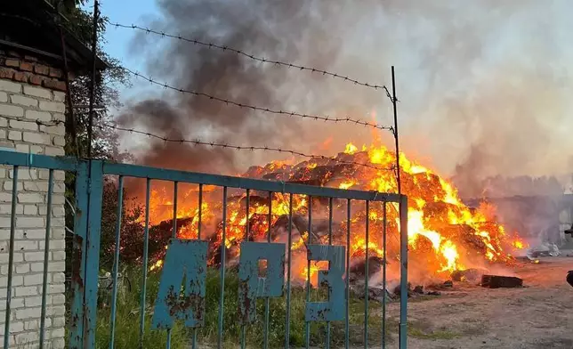 In this photo released by Acting Governor of the Kursk Region Alexander Khinshtein telegram channel on Saturday, May 31, 2025, a view of a fire at the territory of an agrofirm after Ukrainian drones struck near Rylsk in the western Kursk region of Russia. (Acting Governor of the Kursk Region Alexander Khinshtein via AP)