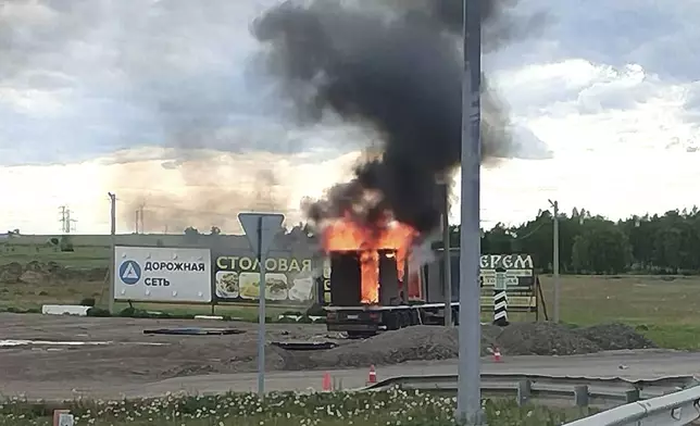 This photo released by Governor of Irkutsk region Igor Kobzev telegram channel on Sunday, June 1, 2025, shows a truck apparently used to release Ukrainian drones seen burning in the Irkutsk region, more than 4,000 kilometers (2,500 miles) from Ukraine. (Governor of Irkutsk region Igor Kobzev telegram channel via AP)