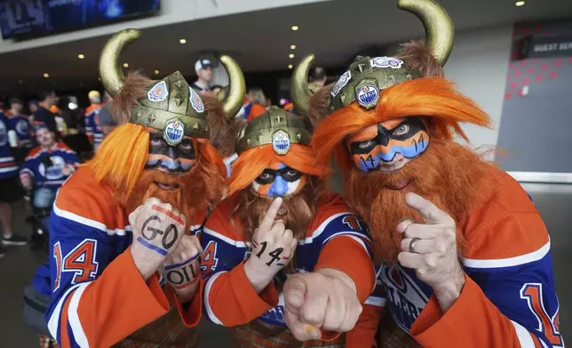 Fans show their support for the Edmonton Oilers before they take on the Florida Panthers in Game 1 of the NHL hockey Stanley Cup final series in Edmonton, Alberta, Wednesday, June 4, 2025. (Darryl Dyck/The Canadian Press via AP)