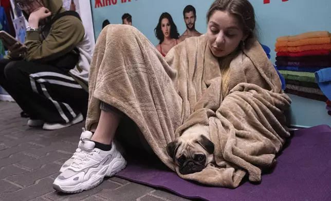 People rest in a metro station, being used as a bomb shelter, during a Russian drones attack in Kyiv, Ukraine, early Tuesday, June 10, 2025. (AP Photo/Zoya Shu)
