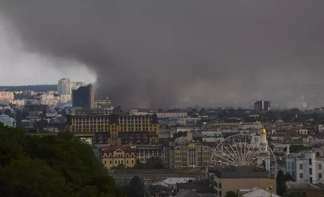 Smoke covers the sky above the city following Russia's massive missile and drone attack in Kyiv, Ukraine, Tuesday, June 10, 2025. (AP Photo/Efrem Lukatsky)