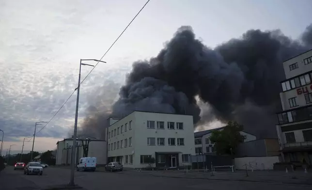 Smoke rises above a building destroyed by a Russian drone strike on Kyiv, Ukraine, Tuesday, June 10, 2025. (AP Photo/Evgeniy Maloletka)