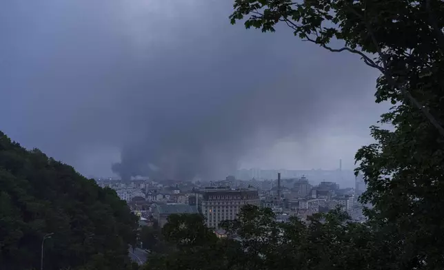 Smoke rises after Russian drone strike on Kyiv, Ukraine, Tuesday, June 10, 2025. (AP Photo/Evgeniy Maloletka)