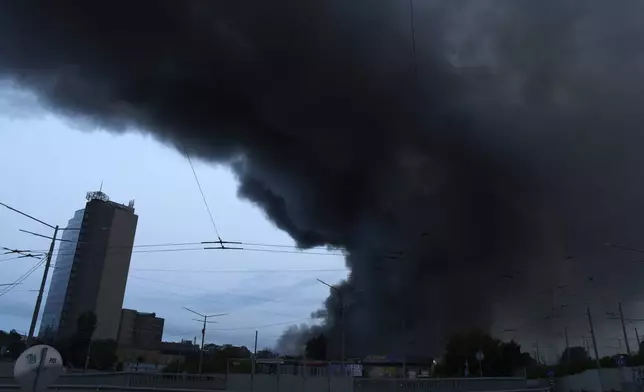 Smoke covers the sky above the city following Russia's missile and drone attack in Kyiv, Ukraine, Tuesday, June 10, 2025. (AP Photo/Efrem Lukatsky)