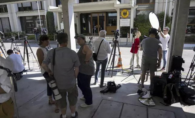 TV journalists work in front of the German Mission to the UN, ahead of a meeting for the Iran-EU nuclear meeting with the various foreign ministers of Germany, France, Great Britain and the EU to hold nuclear talks with their Iranian counterparts, in Geneva, Switzerland, Friday, June 20, 2025. (Martial Trezzini/Keystone via AP)