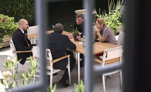France's Minister for Europe and Foreign Affairs Jean-Noel Barrot, from left, Britain's Foreign Secretary David Lammy, Germany's Foreign Minister Johann Wadephul and European Union High Representative for Foreign Affairs and Security Policy, Kaja Kallas, meet at an outdoor terrace table at the offices of the honorary Consul of the Federal Republic of Germany in Geneva, Friday, June 20, 2025. (Fabrice Coffrini/Keystone via AP)
