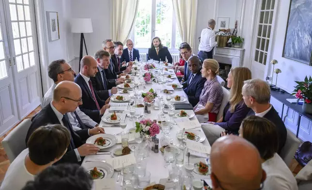 France's Minister for Europe and Foreign Affairs Jean-Noel Barrot, 4th left, Britain's Foreign Secretary David Lammy, 6th right, Germany's Foreign Minister Johann Wadephul, 5th left, and European Union High Representative for Foreign Affairs and Security Policy, Kaja Kallas, 5th right, attend a work lunch at the offices of the honorary Consul of the Federal Republic of Germany in Geneva, Friday, June 20, 2025. (Fabrice Coffrini/Keystone via AP)