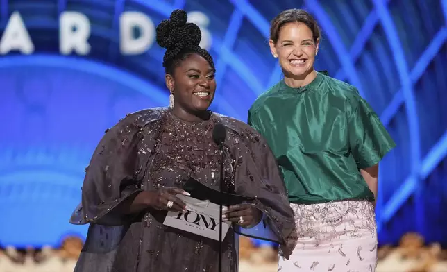 Danielle Brooks, left, and Katie Holmes present the award for best performance by an actor in a featured role in a play during the 78th Tony Awards on Sunday, June 8, 2025, at Radio City Music Hall in New York. (Photo by Charles Sykes/Invision/AP)