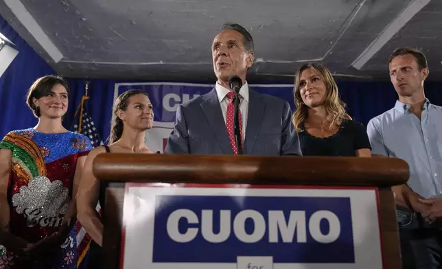 Joined by his daughters, from left, Michaela Kennedy-Cuomo, Cara Kennedy-Cuomo, Mariah Kennedy-Cuomo and son-in-law Tellef Lundevall, mayoral candidate Andrew Cuomo, center, speaks to supporters during a Democratic primary watch party, Tuesday, June 24, 2025, in New York. (AP Photo/Yuki Iwamura)