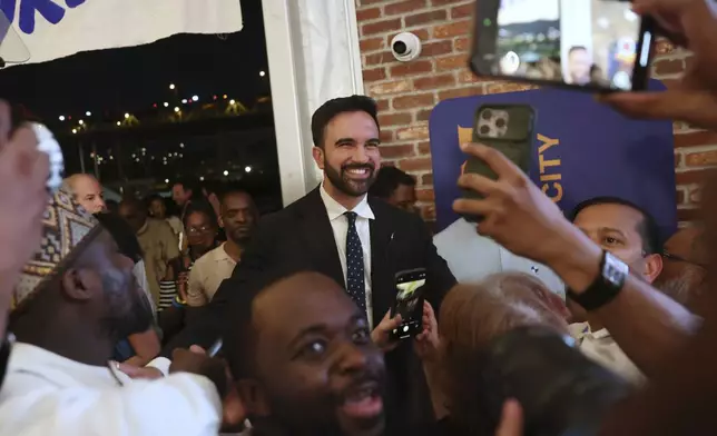Democratic mayoral candidate Zohran Mamdani takes selfies with supporters after speaking at his primary election party, Wednesday, June 25, 2025, in New York. (AP Photo/Heather Khalifa)
