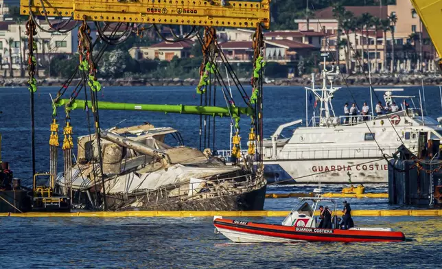 The hull of the superyacht Bayesian, which sank near Palermo, Sicily, on August 19, 2024, is lifted by cranes during salvage operations off the village of Porticello Saturday, June 21, 2025. (AP Photo/Salvatore Cavalli)