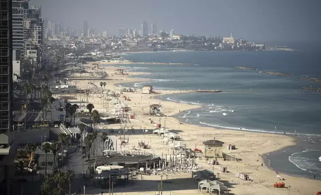 A general view shows the mostly empty beachfront in Tel Aviv, Friday, June 13, 2025. (AP Photo/Leo Correa)