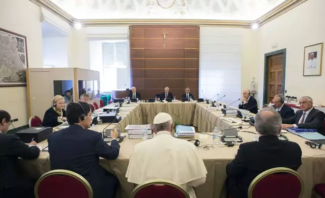 FILE - Pope Francis attends the IOR (Institute for Religious Works) Vatican Bank's council, at the Vatican, Tuesday, Nov. 24, 2015. (L'Osservatore Romano/Pool Photo via AP)