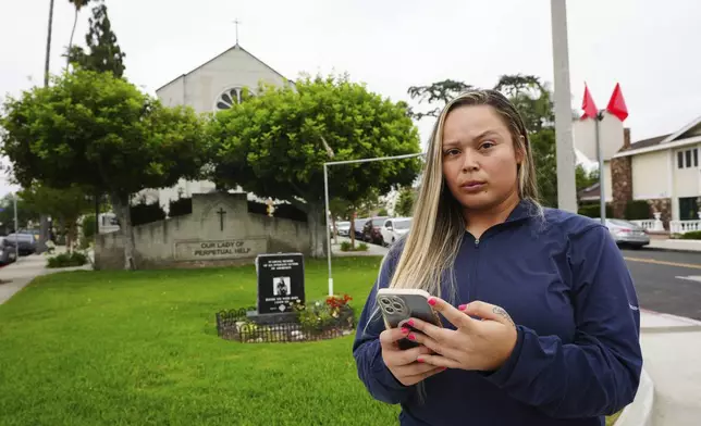Melyssa Rivas poses for a photo at a location where she witnessed masked federal agents detaining a person earlier this month outside Our Lady of Perpetual Help Catholic Church in Downey, Calif., on Friday, June 20, 2025. (AP Photo/Damian Dovarganes)