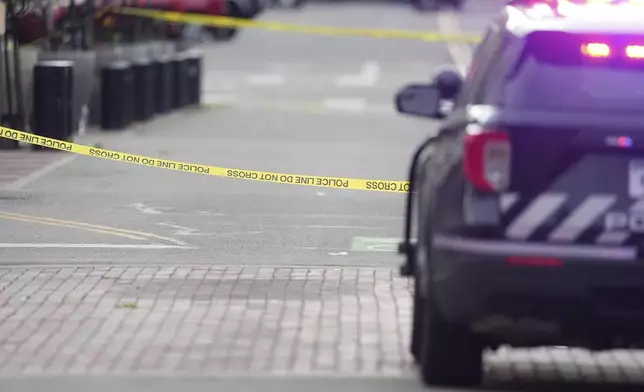 Crime scene tape blocks off the intersection on Pearl Street as law enforcement officials investigate after an attack on the pedestrian mall Sunday, June 1, 2025, in Boulder, Colo. (AP Photo/David Zalubowski)
