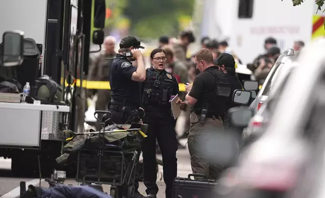 Law enforcement officials investigate after an attack on the Pearl Street Mall Sunday, June 1, 2025, in Boulder, Colo. (AP Photo/David Zalubowski)