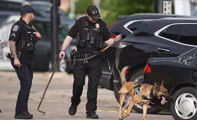 Law enforcement officials investigate after an attack on the Pearl Street Mall Sunday, June 1, 2025, in Boulder, Colo. (AP Photo/David Zalubowski)