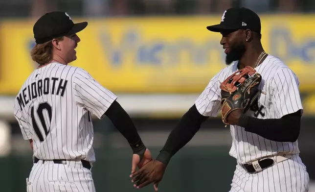 Chicago White Sox shortstop Chase Meidroth (10), left, and center fielder Luis Robert Jr. (88) celebrate their team's win over the Kansas City Royals in a baseball game Saturday, June 7, 2025, in Chicago. (AP Photo/Erin Hooley)