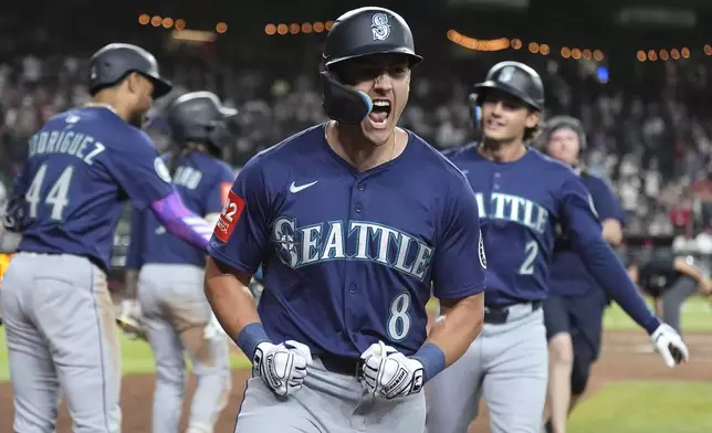 Seattle Mariners' Dominic Canzone celebrates his two-run home run against the Arizona Diamondbacks during the ninth inning of a baseball game Monday, June 9, 2025, in Phoenix. (AP Photo/Ross D. Franklin)