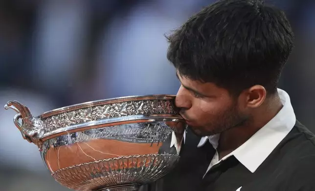 Spain's Carlos Alcaraz celebrates with the trophy after winning the final match of the French Tennis Open against Italy's Jannik Sinner at the Roland-Garros stadium in Paris, Sunday, June 8, 2025. (AP Photo/Lindsey Wasson)