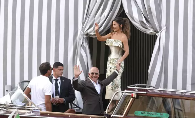 Jeff Bezos, center left, and Lauren Sanchez, center right, leave a hotel for their pre wedding reception, in Venice, Italy, Thursday, June 26, 2025. (AP Photo/Luca Bruno)