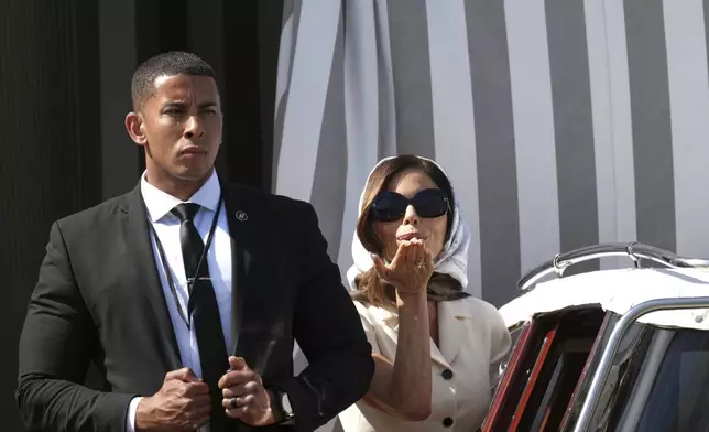 Lauren Sanchez, right, leaves a hotel ahead of the anticipated wedding celebrations with Jeff Bezos, in Venice, Italy, Friday, June 27, 2025. (AP Photo/Antonio Calanni)