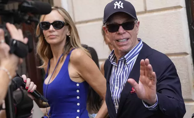 CORRECTS TO HILFIGER, NOT HILFINGER - Tommy Hilfiger and his wife Dee Ocleppo leave Harry's Bar in Venice, Italy, Saturday,June 28, 2025. (AP Photo/Luca Bruno)