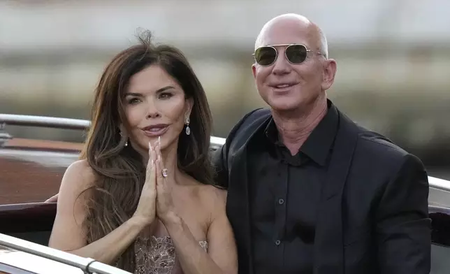 Lauren Sanchez Bezos, left, and Jeff Bezos depart from the Aman hotel during wedding celebrations in Venice, Italy, Saturday, June 28, 2025. (AP Photo/Luca Bruno)