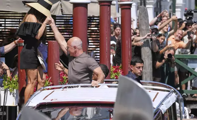 Jeff Bezos and Lauren Sanchez Bezos leave the Harry's Bar in Venice, Italy, Saturday,June 28, 2025. (AP Photo/Antonio Calanni)