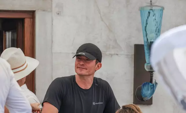 Orlando Bloom leaves his hotel, Friday, June 27, 2025 ahead of the anticipated wedding celebrations of Jeff Bezos and Lauren Sanchez. (AP Photo/Antonio Calanni)