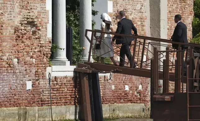 Lauren Sanchez, left, arrives at San Giorgio island ahead of the anticipated wedding celebrations with Jeff Bezos, in Venice, Italy, Friday, June 27, 2025. (AP Photo/Antonio Calanni)