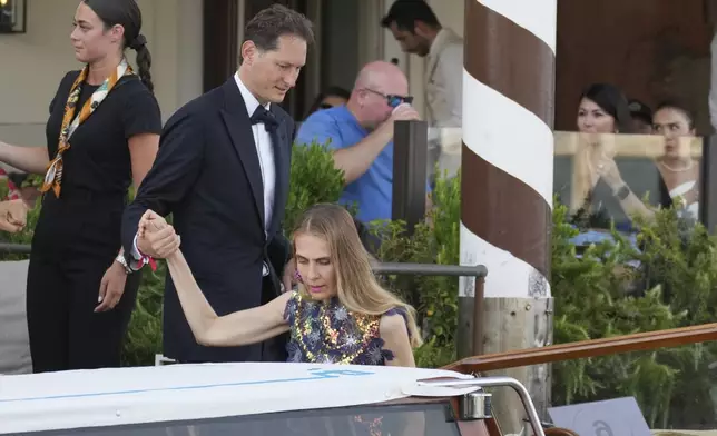 John Elkann, center left, and Lavinia Borromeo leave a hotel ahead of the anticipated wedding celebrations of Jeff Bezos and Lauren Sanchez, in Venice, Italy, Friday, June 27, 2025. (AP Photo/Antonio Calanni)