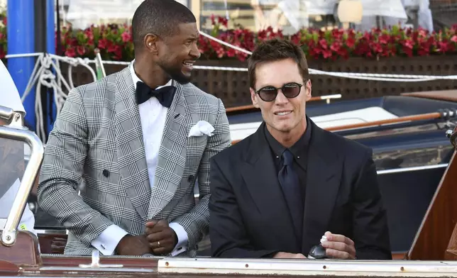 Usher, left, and Tom Brady leave a hotel ahead of the anticipated wedding celebrations of Jeff Bezos and Lauren Sanchez, in Venice, Italy, Friday, June 27, 2025. (AP Photo/Luigi Costantini)
