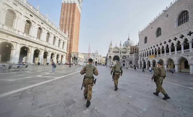 Italian Army soldiers patrol St. Mark’s Square ahead of the weekend wedding of Amazon founder Jeff Bezos and Lauren Sanchez, in Venice, Italy, Thursday, June 26, 2025. (AP Photo/Luca Bruno)