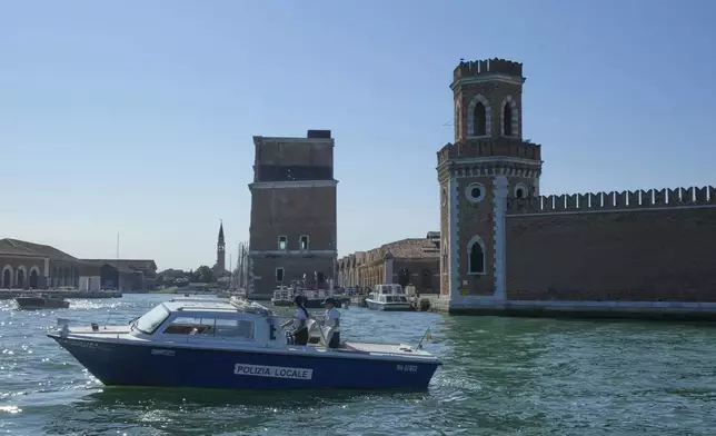 Police patrol the water in front of the Venice Arsenale in Venice, Italy, Saturday, June 28, 2025. (AP Photo/Luca Bruno)