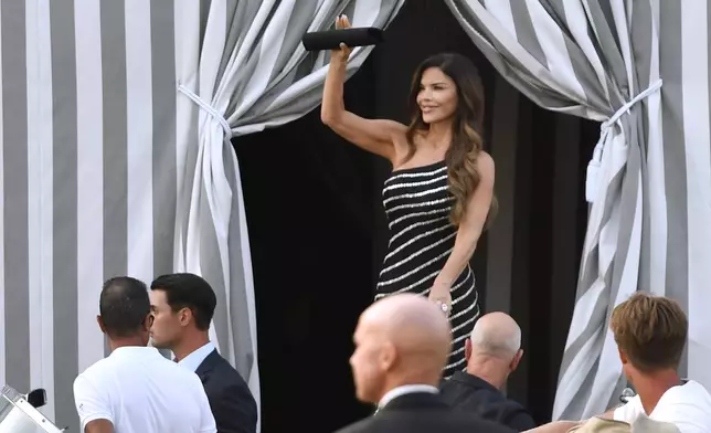 Lauren Sanchez waves as she and Jeff Bezos arrive in Venice, Italy, Thursday, June 26, 2025. (AP Photo/Luigi Costantini)
