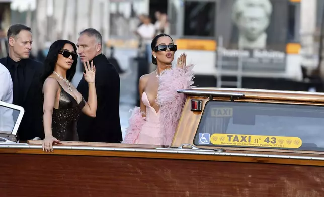 Kim Kardashian, left, and Khloé Kardashian leave a hotel ahead of the anticipated wedding celebrations of Jeff Bezos and Lauren Sanchez, in Venice, Italy, Friday, June 27, 2025. (AP Photo/Luigi Costantini)