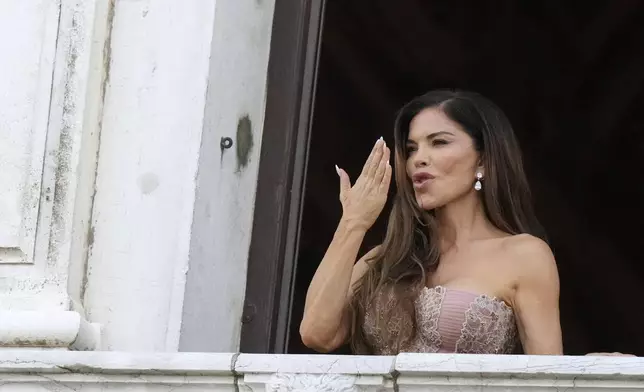 Lauren Sanchez Bezos blows a kiss from her balcony, in Venice, Italy, Saturday, June 28, 2025. (AP Photo/Luca Bruno)