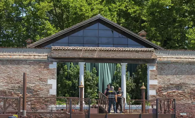 Security staff stand on a dock of San Giorgio Island in Venice, Italy, Friday,June 27, 2025 ahead of the anticipated wedding celebrations of Jeff Bezos and Lauren Sanchez. (AP Photo/Antonio Calanni)