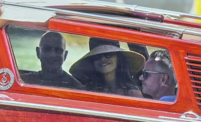 Lauren Sanchez and Jeff Bezos, left, leave their hotel in Venice, Italy, Saturday,June 28, 2025, the day after their wedding. (AP Photo/Luca Bruno)