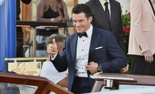 Orlando Bloom leaves a hotel ahead of the anticipated wedding celebrations of Jeff Bezos and Lauren Sanchez, in Venice, Italy, Friday, June 27, 2025. (AP Photo/Luigi Costantini)