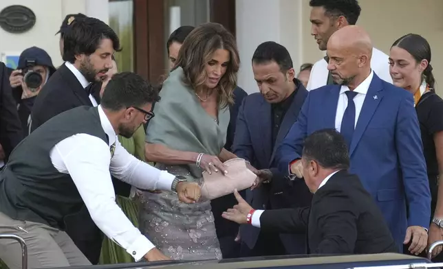 Queen Rania of Jordan, center, leaves a hotel ahead of the anticipated wedding celebrations of Jeff Bezos and Lauren Sanchez, in Venice, Italy, Friday, June 27, 2025. (AP Photo/Antonio Calanni)