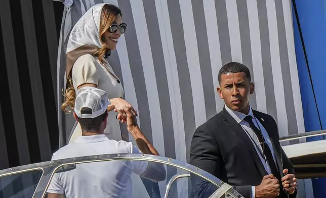 Lauren Sanchez, left, leaves her hotel in Venice, Italy, Friday,June 27, 2025 ahead of the anticipated wedding celebrations with Jeff Bezos. (AP Photo/Luca Bruno)