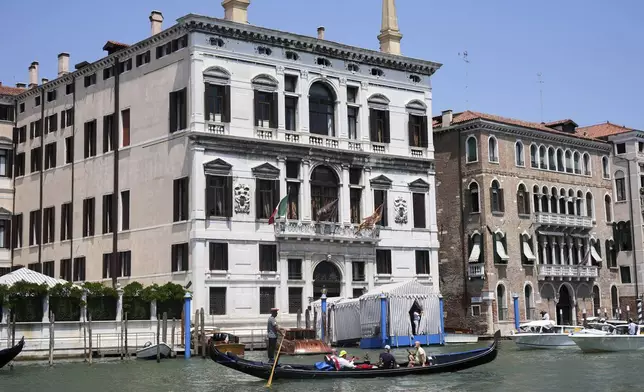 A gondola sails past the Annan Hotel in Venice, Italy, on Thursday, June 26, 2025, ahead of festivities in the lagoon city reportedly linked to a wedding celebration for Jeff Bezos and Lauren Sánchez. (AP Photo/Antonio Calanni)