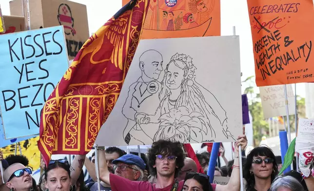 Activists stage a protest in Venice, Italy, Saturday, June 28, 2025, denouncing the three-day celebrations for the wedding between Jeff Bezos and his wife Lauren Sanchez Bezos that took place in Venice on Friday as a symbol of rising inequality and disregard for the city's residents. (AP Photo/Antonio Calanni)