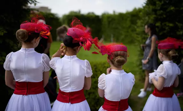 Students of a dance school wait outside Romania's Palace of Parliament during a series of events marking International Children's Day in Bucharest, Romania, Sunday, June 1, 2025. (AP Photo/Andreea Alexandru)
