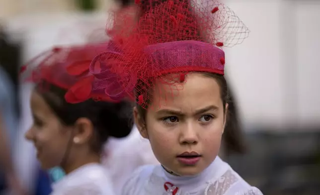 Students of a dance school wait outside Romania's Palace of Parliament during a series of events marking International Children's Day in Bucharest, Romania, Sunday, June 1, 2025. (AP Photo/Andreea Alexandru)