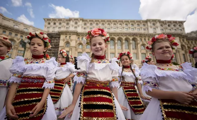 Students of a dance school wait outside Romania's Palace of Parliament during a series of events marking International Children's Day in Bucharest, Romania, Sunday, June 1, 2025. (AP Photo/Andreea Alexandru)