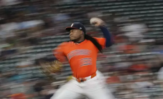 In this image taken with a slow shutter speed, Houston Astros starting pitcher Framber Valdez throws against the Chicago White Sox during the first inning of a baseball game Thursday, June 12, 2025, in Houston. (AP Photo/David J. Phillip)