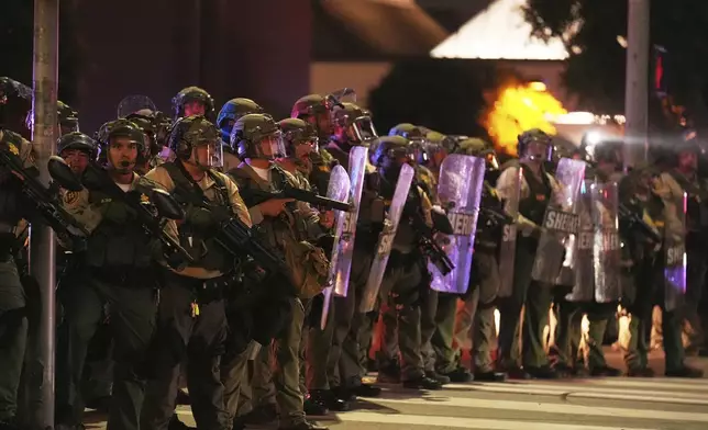 Los Angeles County Sheriff's deputies respond to ICE protests outside the DoubleTree by Hilton Hotel, where ICE agents were believed to be staying, Wednesday, June 11, 2025, in Whittier, Calif. (AP Photo/Chris Pizzello)